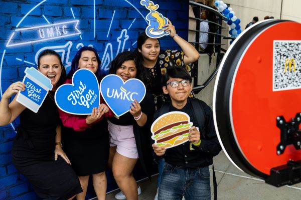 Group of First Gen Roo students pose for a selfie with UMKC signs at a coffee connection event