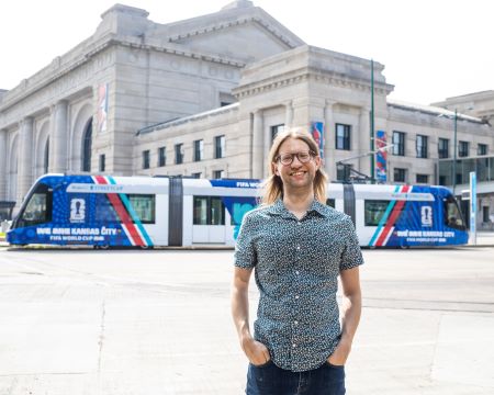 Ian Blair stands in front of Union Station as the streetcar, on which he worked, goes past