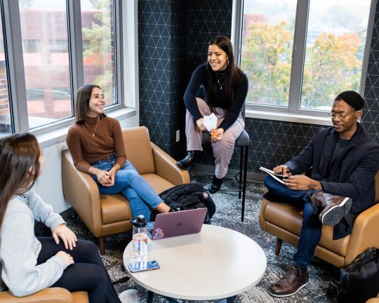 undergraduate students sit in a lounge at the Bloch school