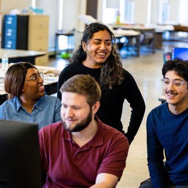 students in the urban planning department stand around a computer