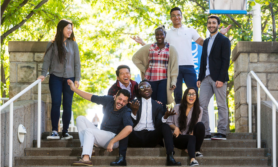 A diverse group of UMKC students gather on the stairs that lead up to UMKC's Volker Campus.