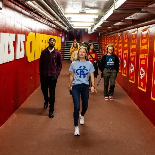 UMKC students walk through hallway at GEHA Field at Arrowhead Stadium for a day of job shadowing and leadership lunches