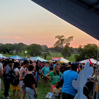 sunset over the Ethnic Enrichment Festival, with Kasey Roo looking out at the crowd