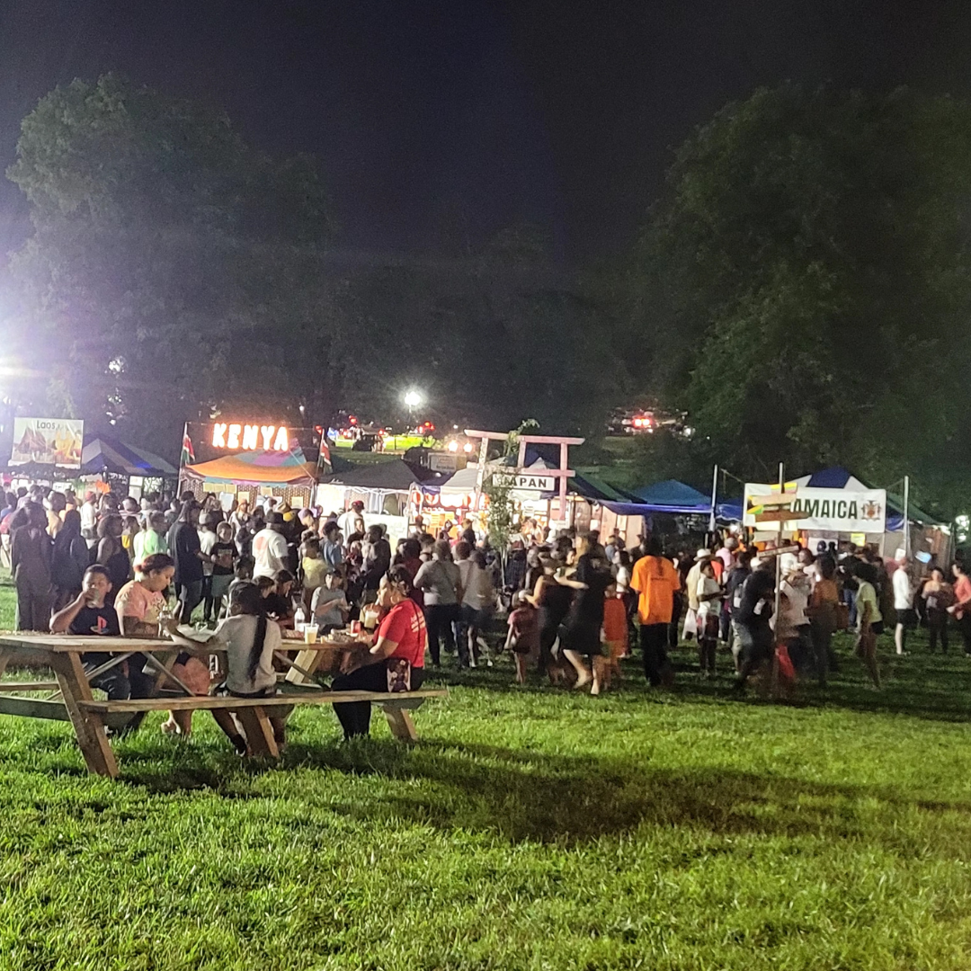 photo of booths such as Kenya, Japan, and Jamaica at the 2023 Ethnic Enrichment Festival at night