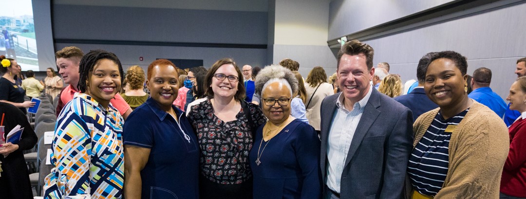 UMKC staff members stand by stage at annual staff awards
