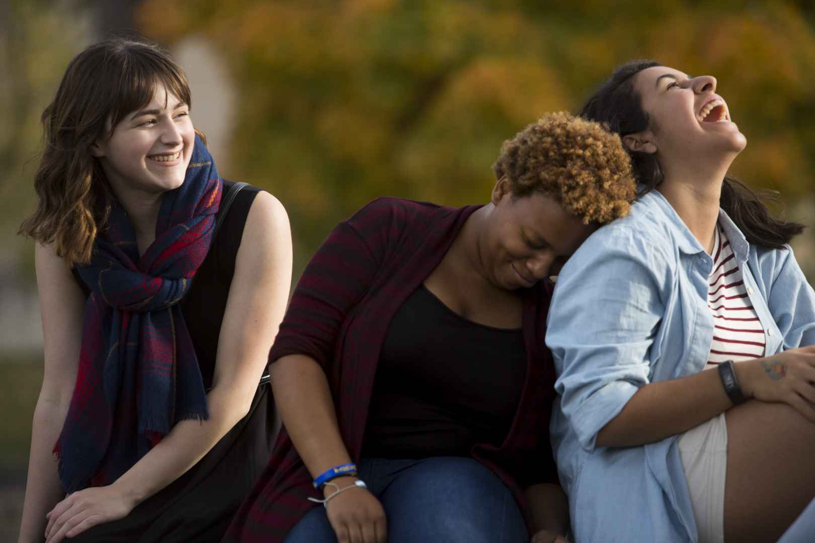 three girls laughing outdoors