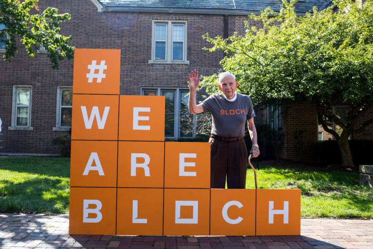 Henry by the rebranded orange block for the UMKC Henry W. Bloch School of Management