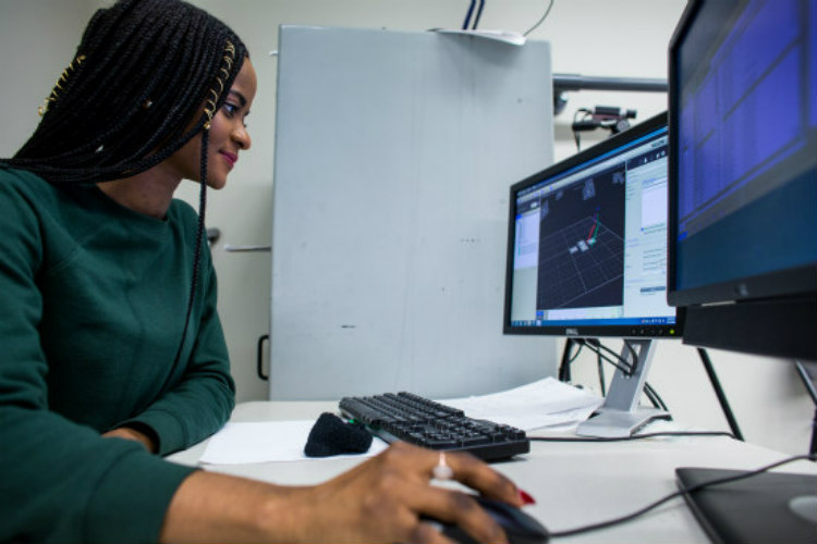 UMKC engineering student Mary Okafor works at a computer in the motions lab.