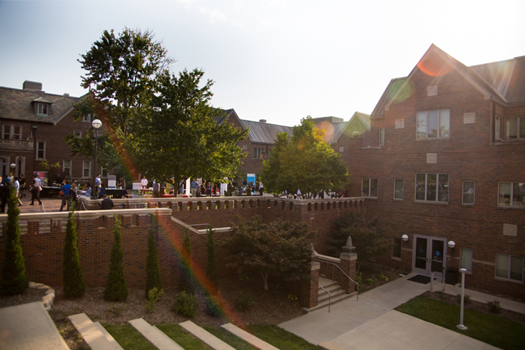 students milling around the career fair booths in the courtyard of Bloch Heritage Hall