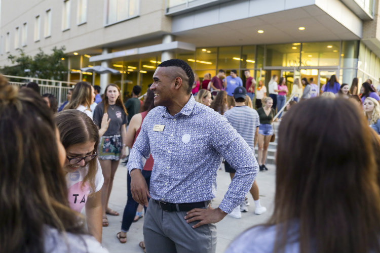 UMKC Student President Justice Horn stands outside of Student Union among his peers.