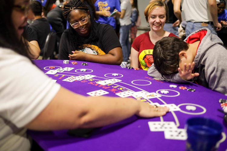 students cheer and lament their luck during Casino Night