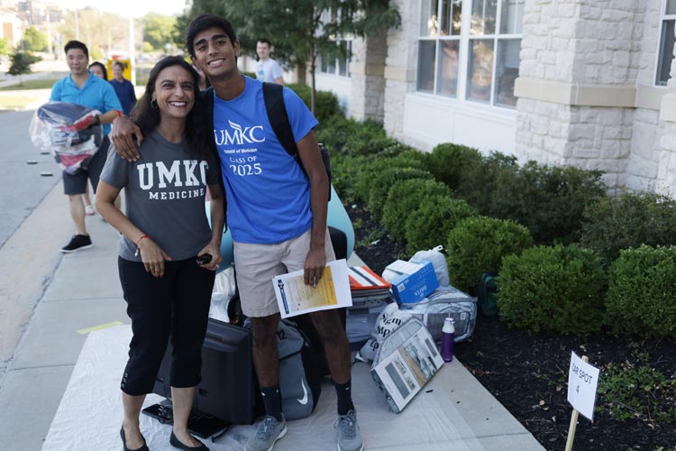 student poses at move-in