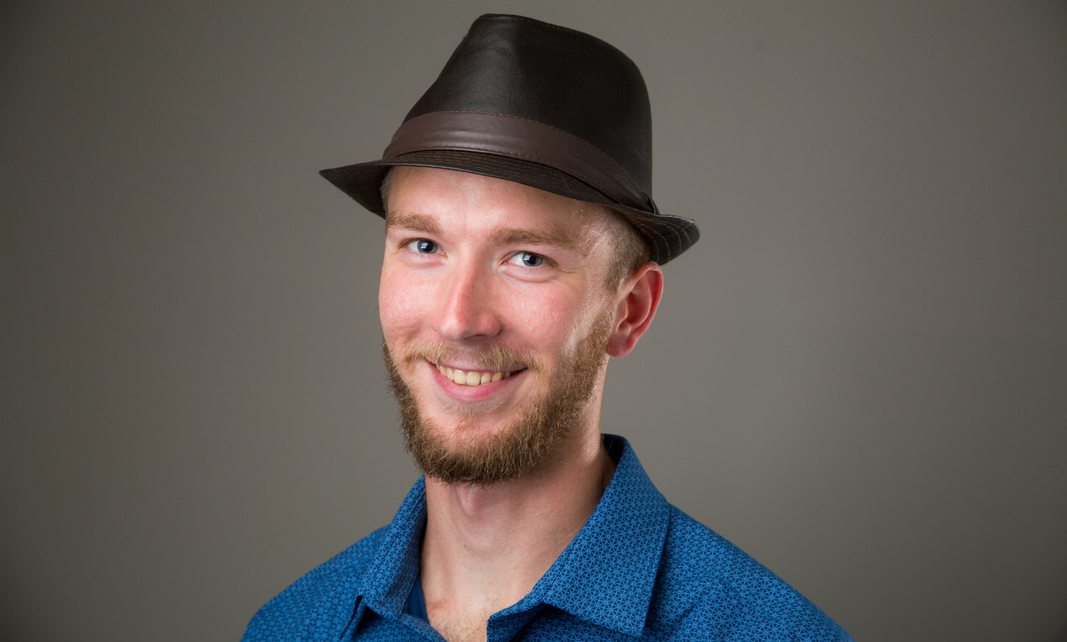 A portrait of student Brian Dieckman, who is wearing a hat