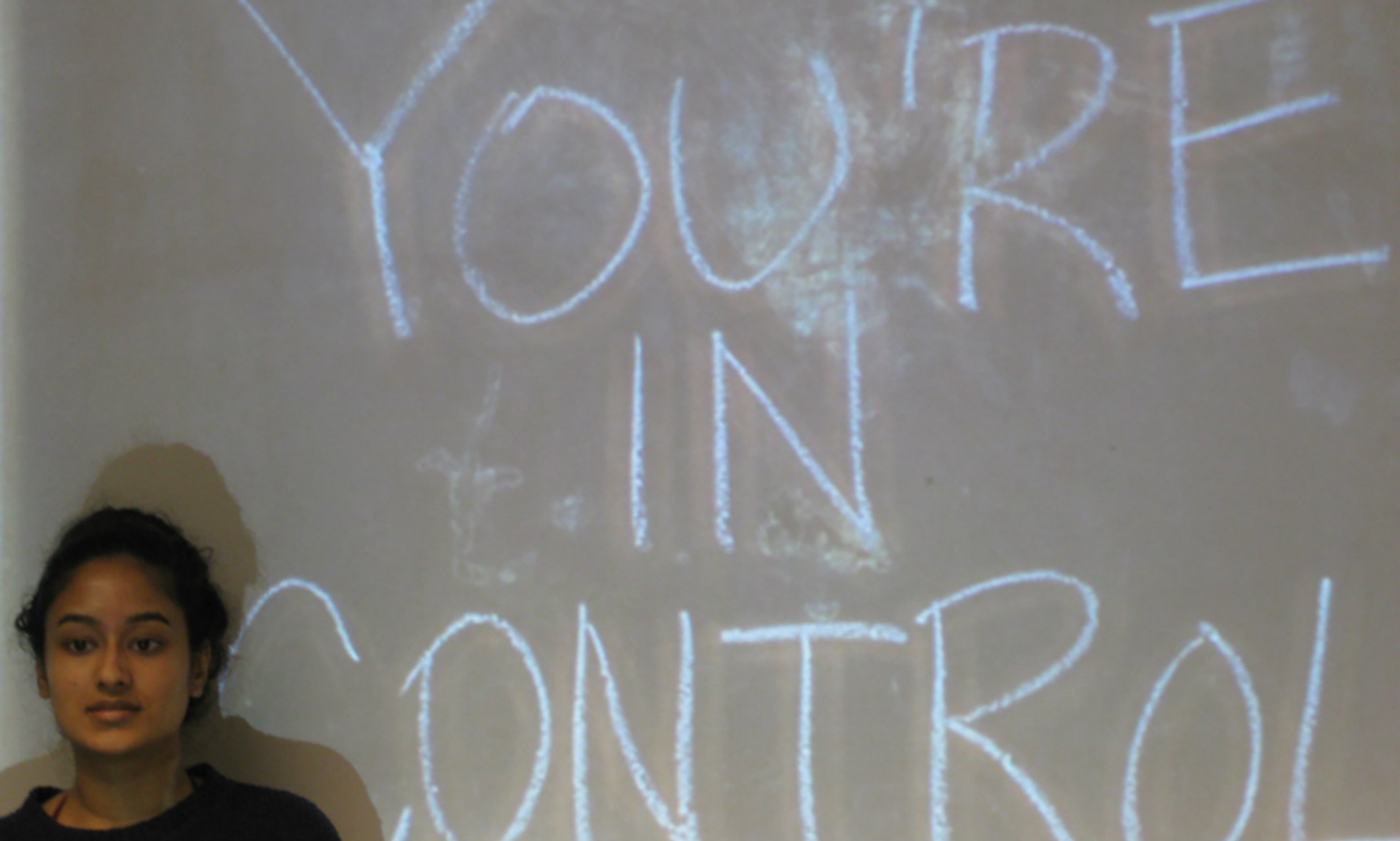 A UMKC School of Medicine student stands in front of a screen.