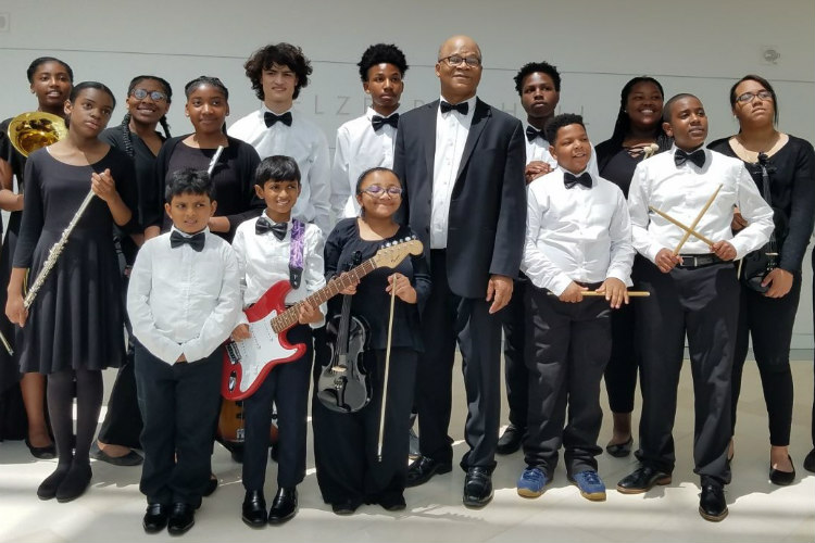 Darryl Chamberlain with members of the A-Flat Youth Orchestra at a performance at Kauffman Center for the Performing Arts