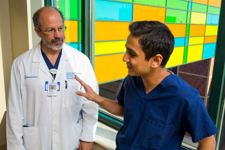 Student Akash Jani and Mike Vlastos, M.D. talk near the Bridge of Hope that connects Children's Mercy with Truman Medical Center
