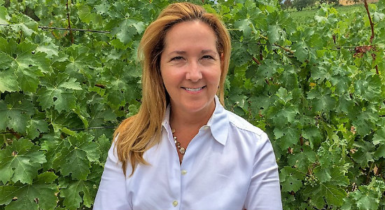 Portrait of Jill Hoffman in a vineyard.