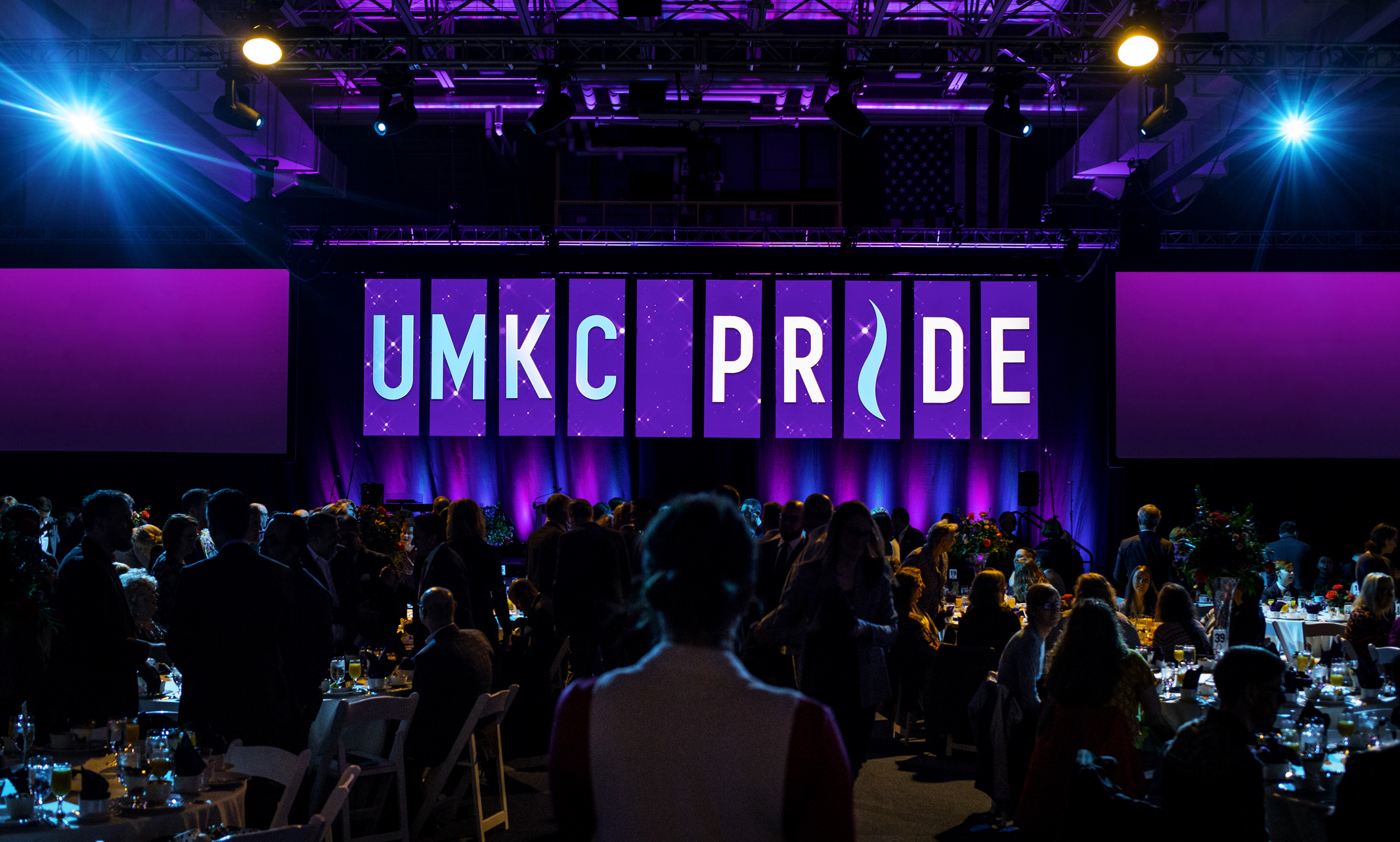 Looking at the UMKC Pride stage lit up with purple and blue lights