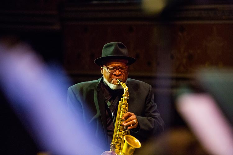 Watson performs on the saxophone