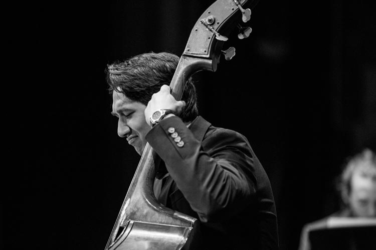 close-up of a jazz bassist enjoying playing
