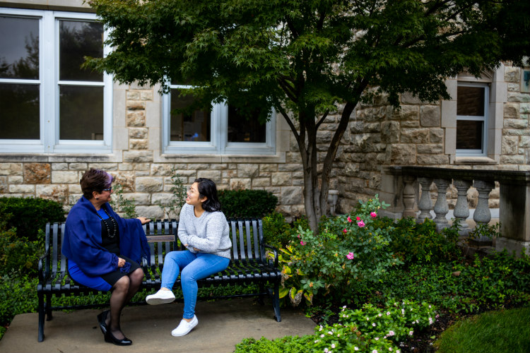 Aricela Guadalupe talks to her mentor on the UMKC Volker Campus.