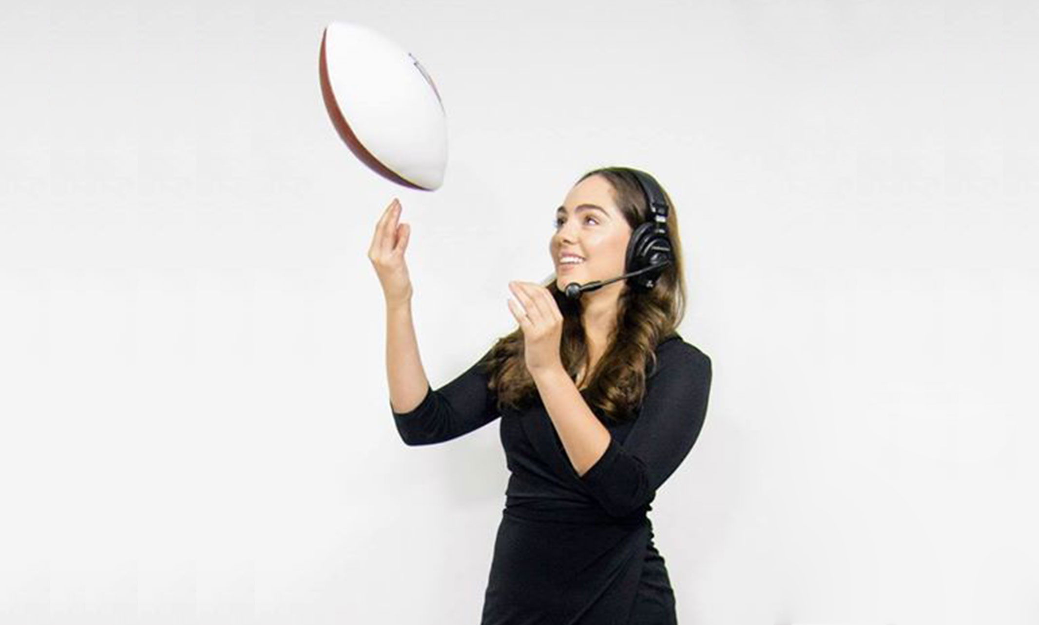 Hannah Bassham tossing a football in promotional photo