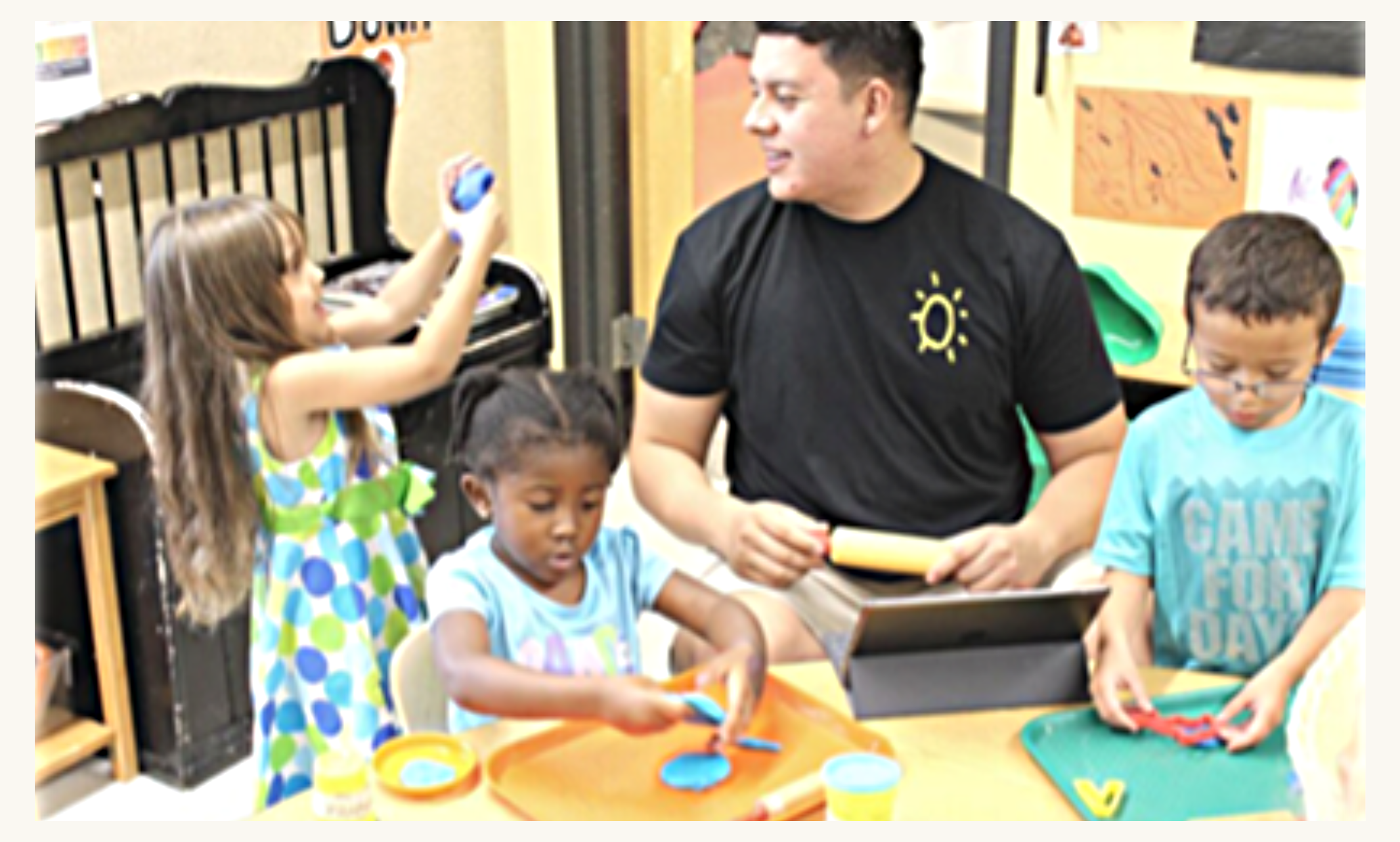 Roberto Diaz working with children on classroom activities