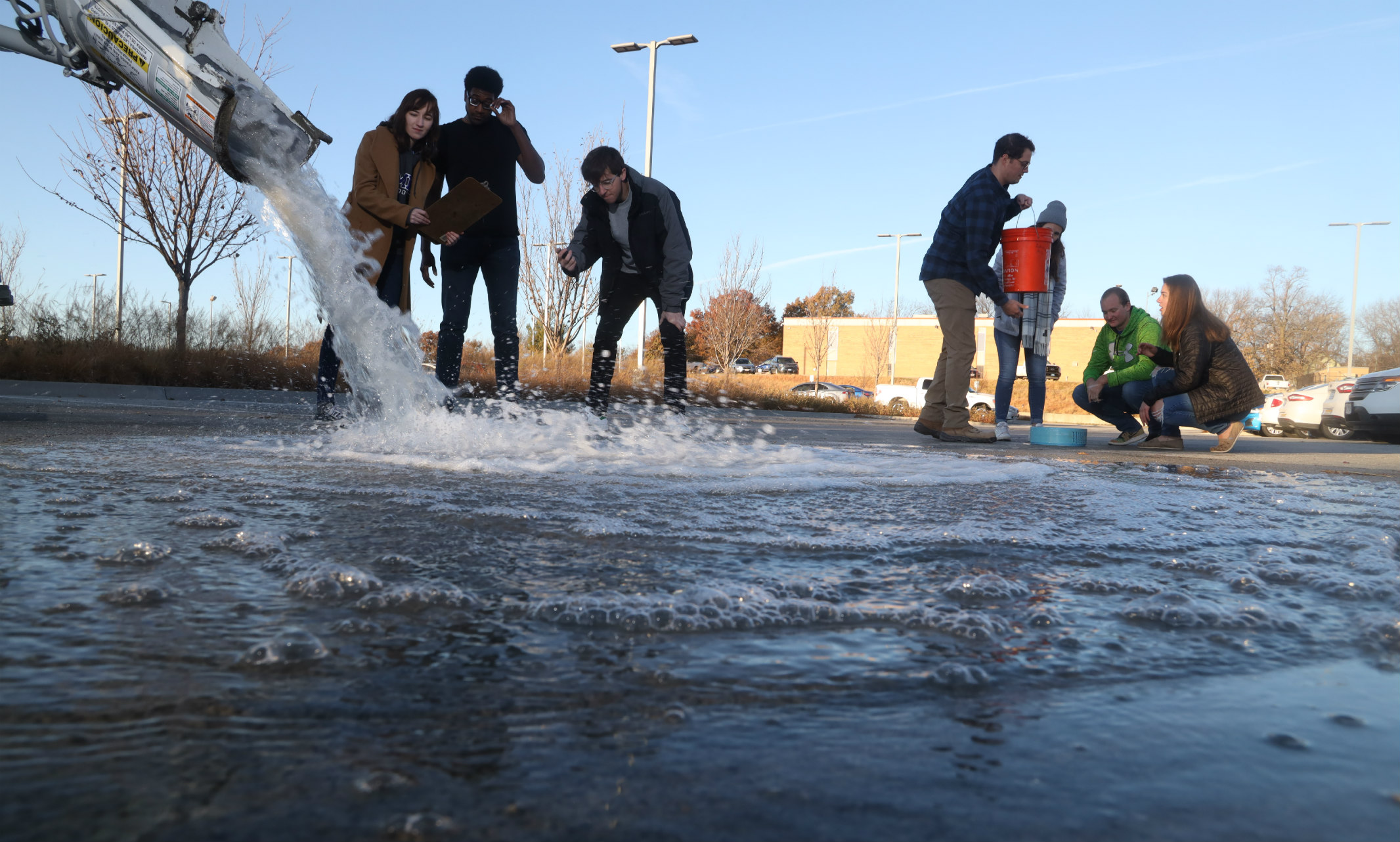 UMKC students measuring water on pervious concrete installed in the parking lot of KC Water