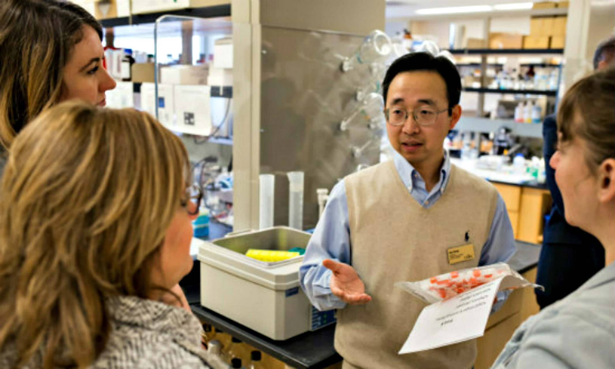 Kun Cheng stands on a tour of his lab