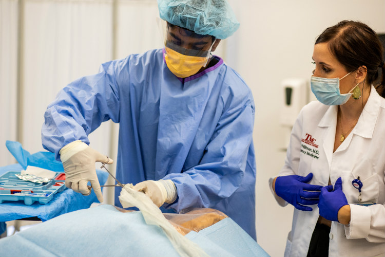med school students in a clinical practice with masks on