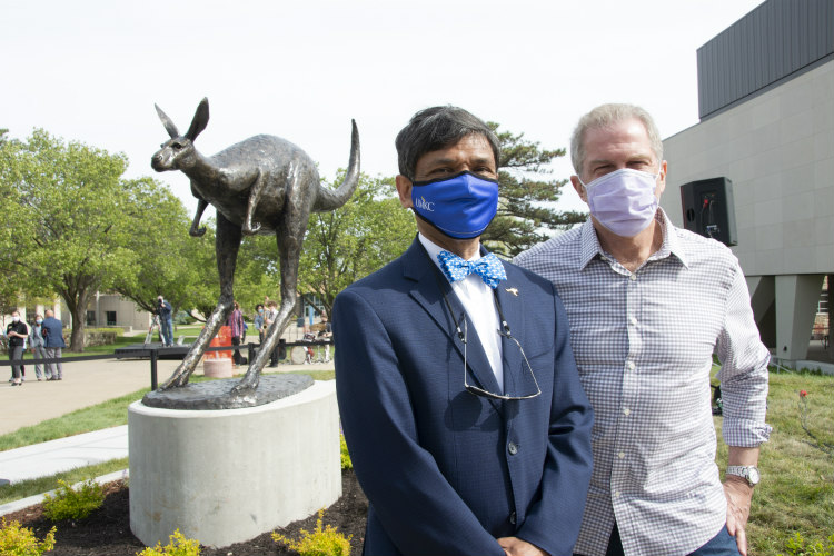 Chancellor Agrawal and Tom Corbin stand in front of Roo statue