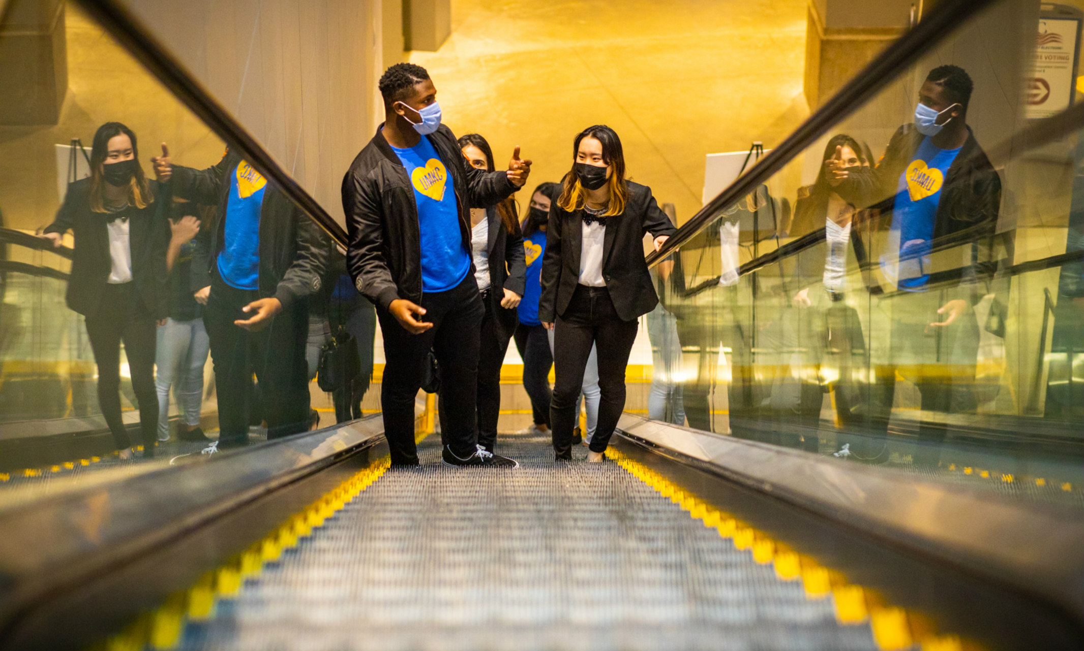 Students ascending on an escalator