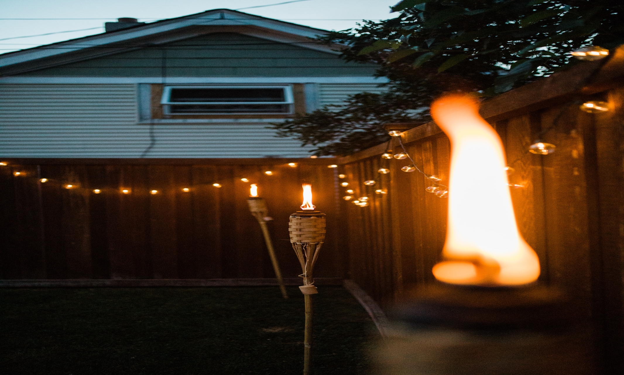 tiki torches lit in backyard.