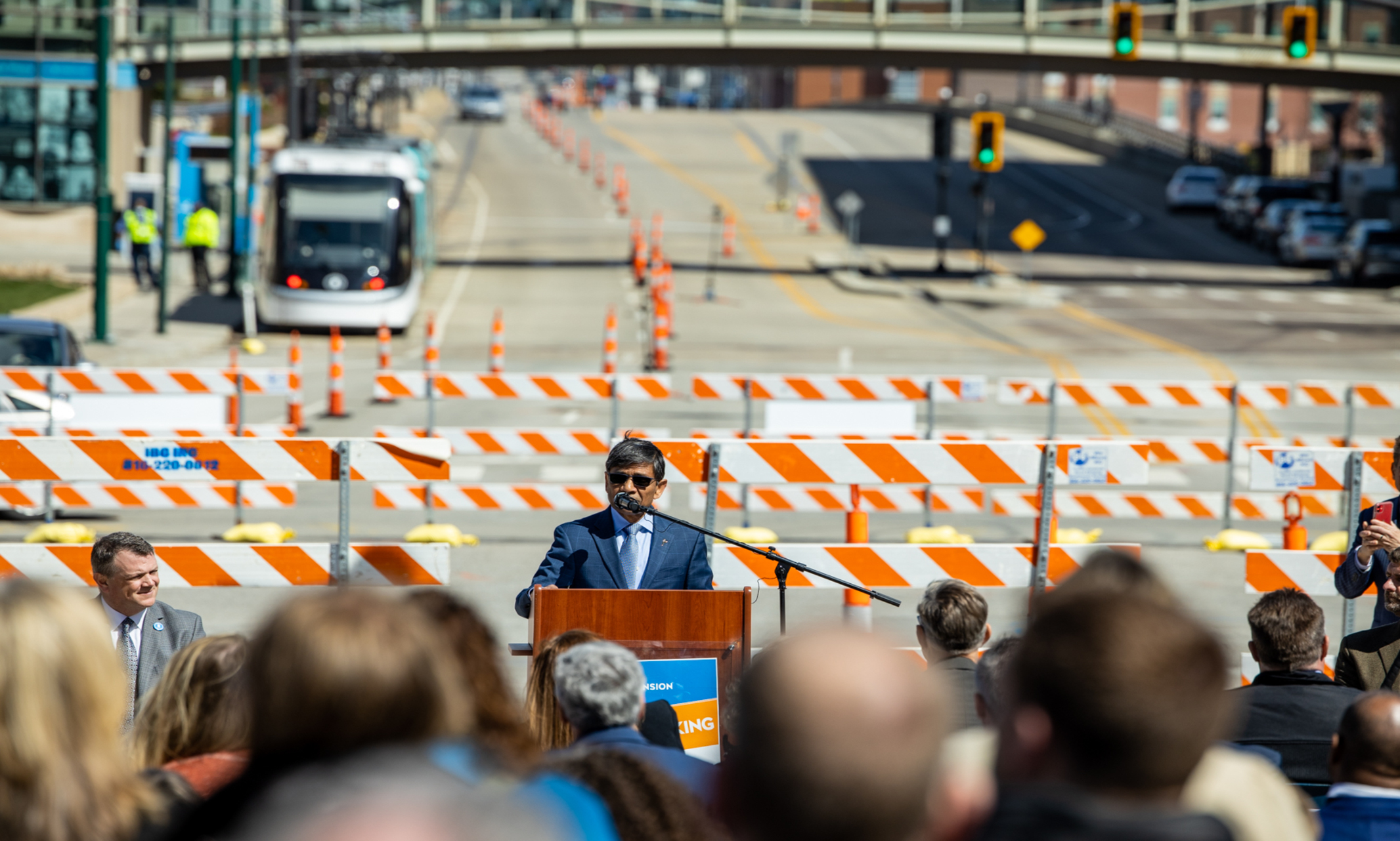 UMKC Chancellor Mauli Agrawal speaks at the event in front of traffic signs 