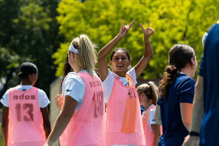 Women's soccer players wear pink jerseys