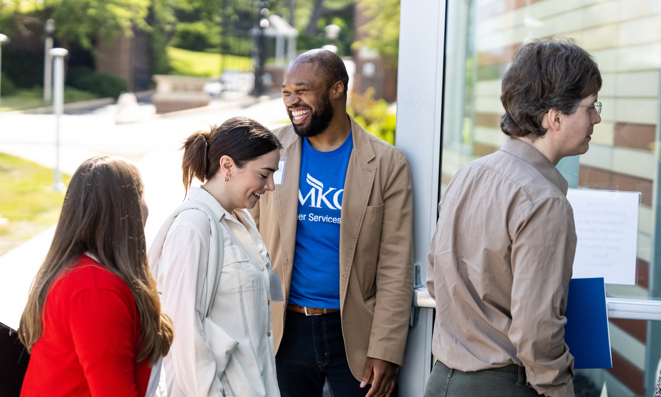 UMKC Career Services employee greets attendees outside of the Student Union