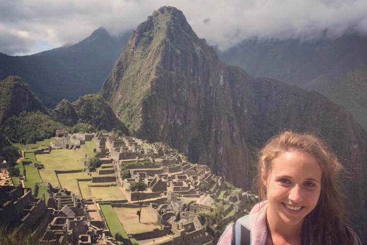 Amanda Pierce stands smiling in front of a mountain in Mexico