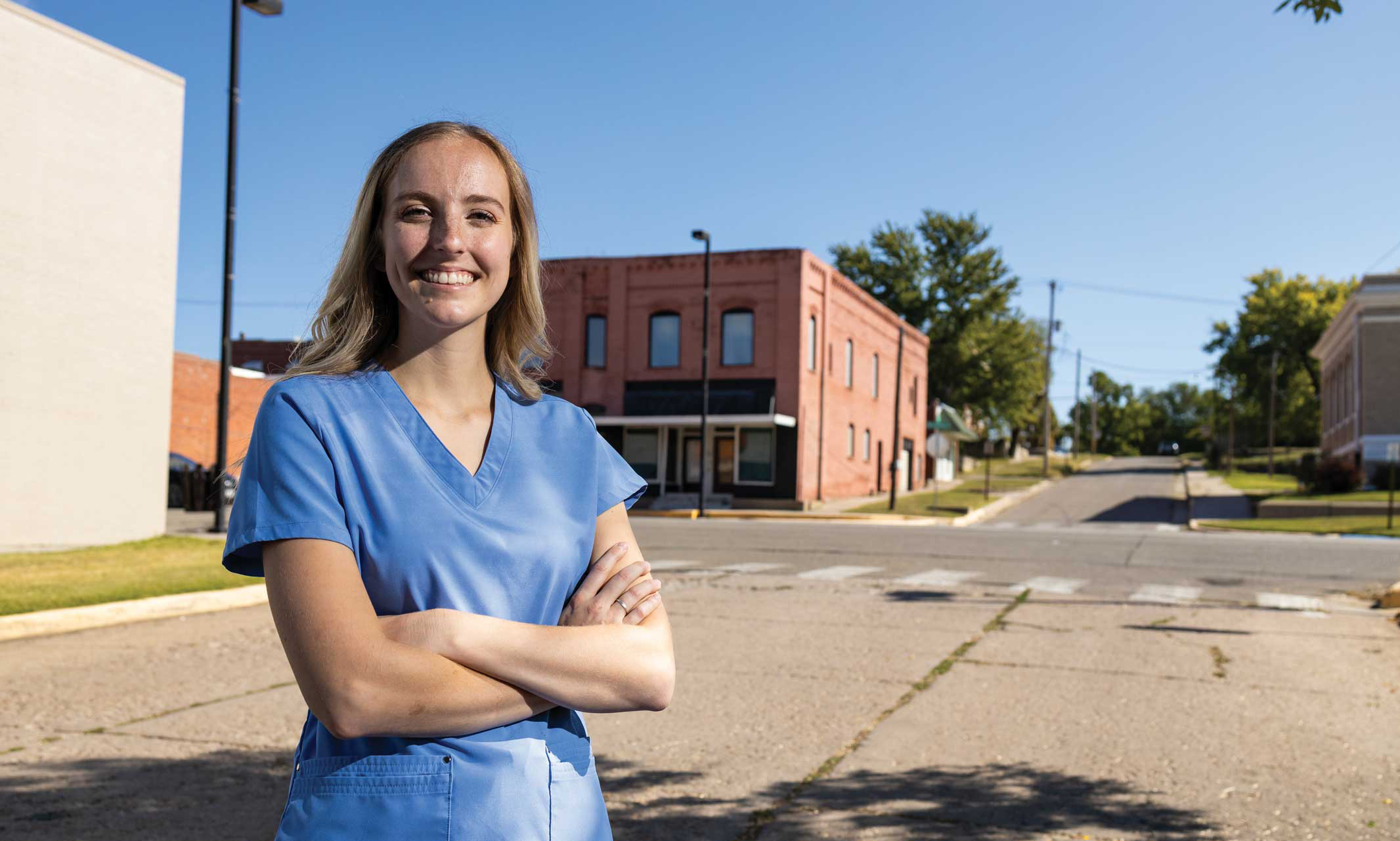 Dental student stands on small town street