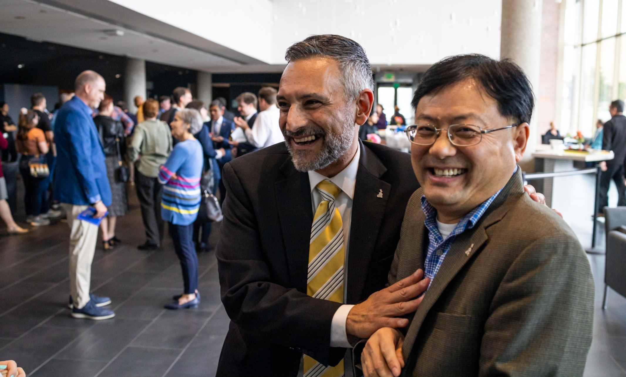 Conservatory Prof. Joseph Parisi and Vice Chancellor for Research and Economic Development Chris Liu share a laugh at post-ceremony reception