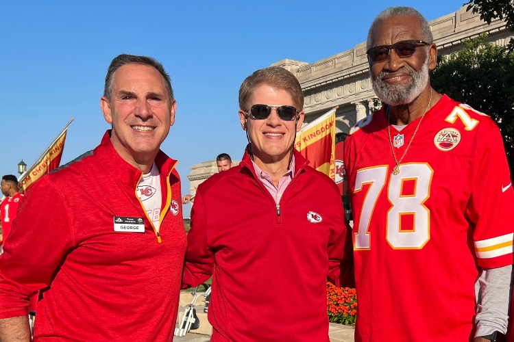 George Guastello stands next to Kansas City Chiefs owner Clark Hunt and former Chiefs player Bobby Bell at Union Station