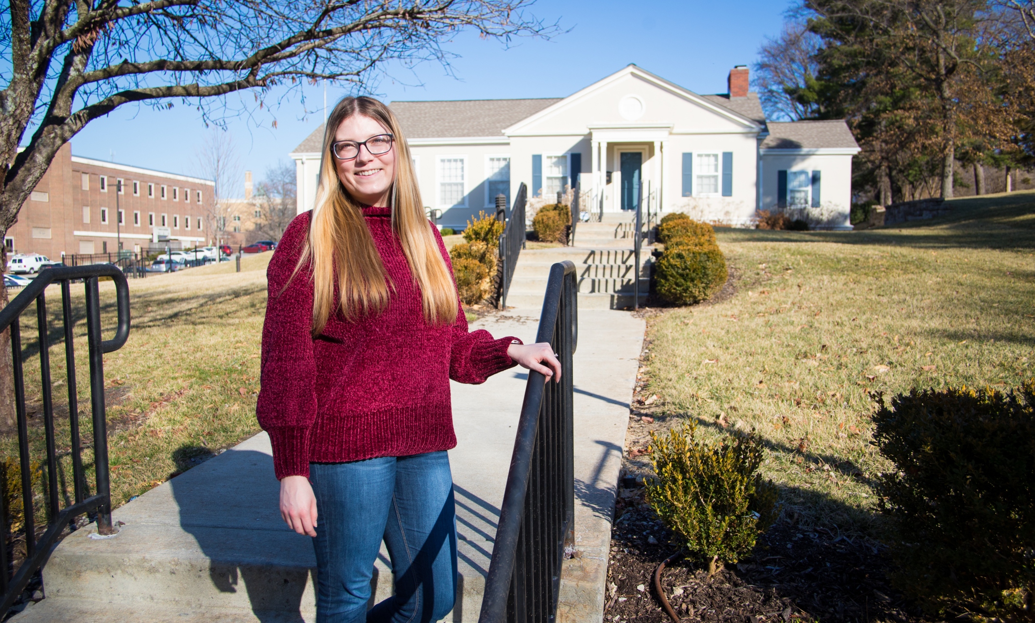 Katy Anielak in front of the Kansas City Young Matrons club house, which is on the Kansas City Women's History Trail