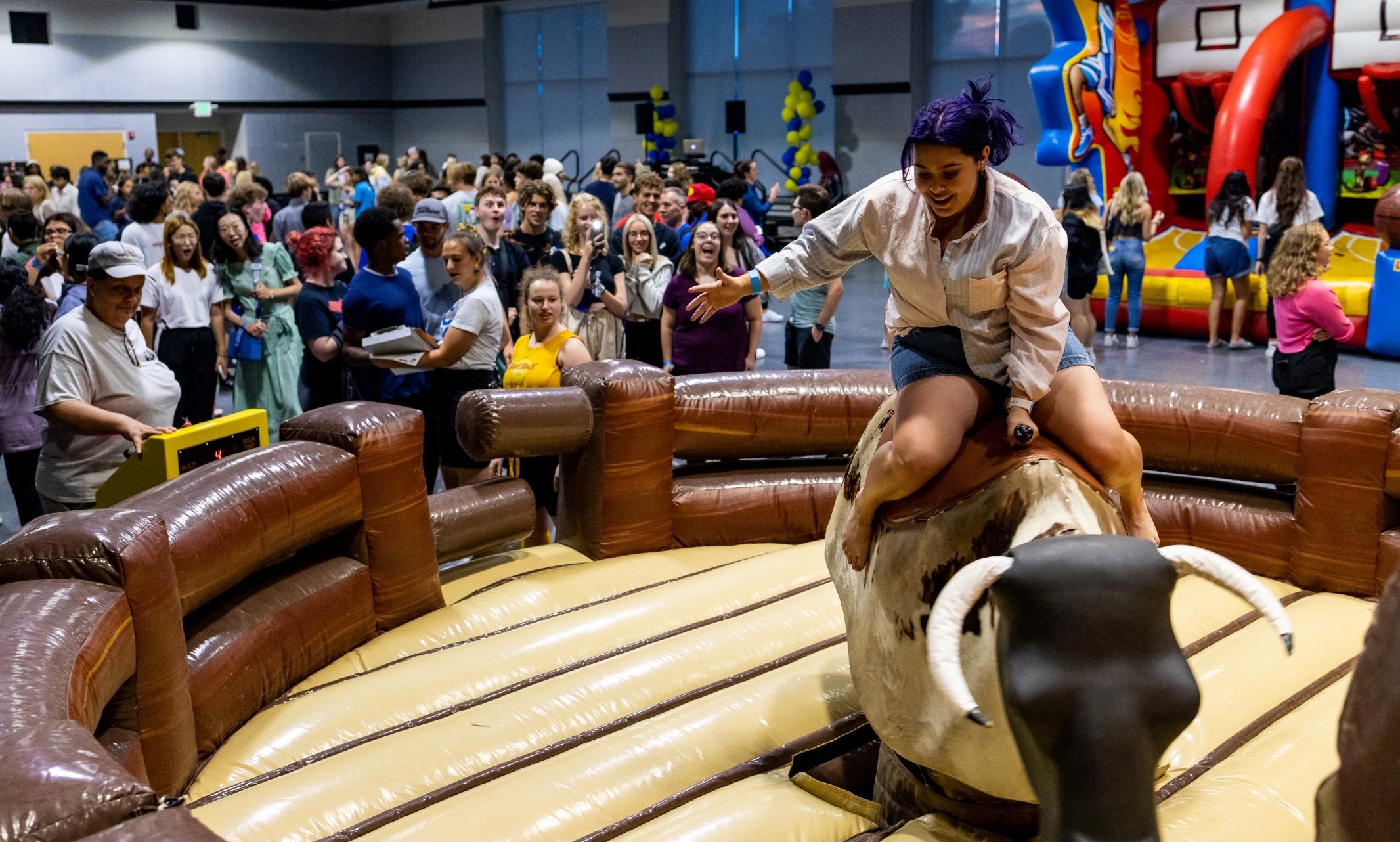 Ariela Lara riding mechanical bull at Late Night with the Greeks freshmen welcome event