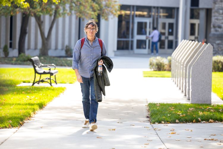 Clancy Martin walks on campus between teaching classes