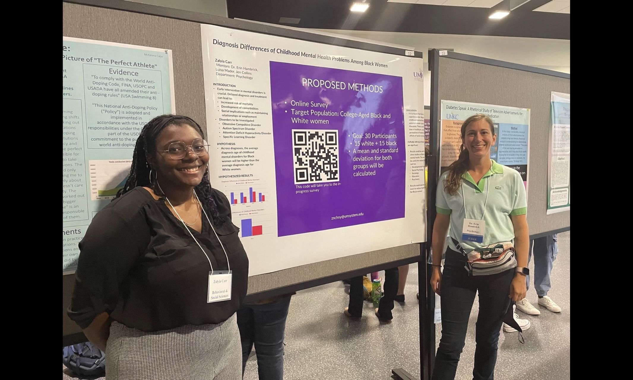Child Psychologist and UMKC professor Erin Hambrick is with former student Zalyia Carr at the SEARCH undergraduate research program at UMKC. They is standing in front of her research paper with Erin Hambrick at the back