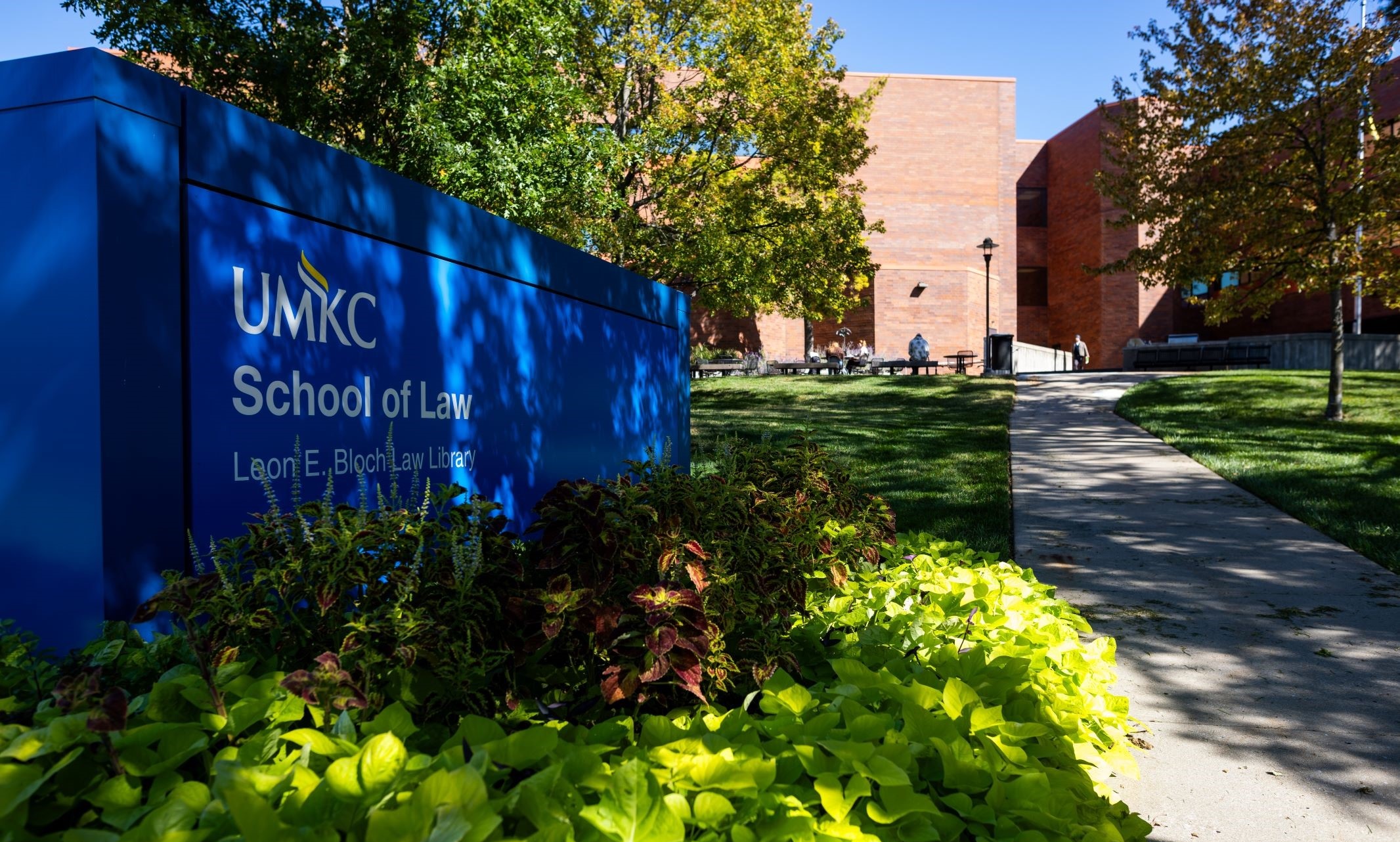 UMKC School of Law sign with the red brick building in the background