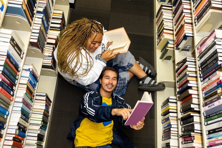 Two students reading books in the Miller Nichols Library