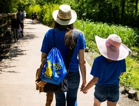 Two visitors walk down one of the accessible pathways at the zoo.
