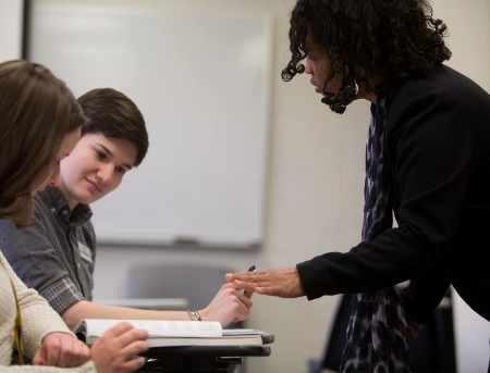 Faculty members talking in a group at a conference.