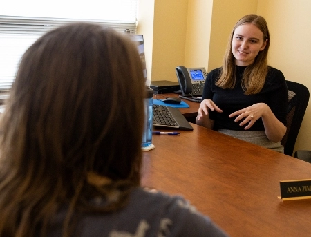 A financial wellness advisor providing guidance to a student in her office.