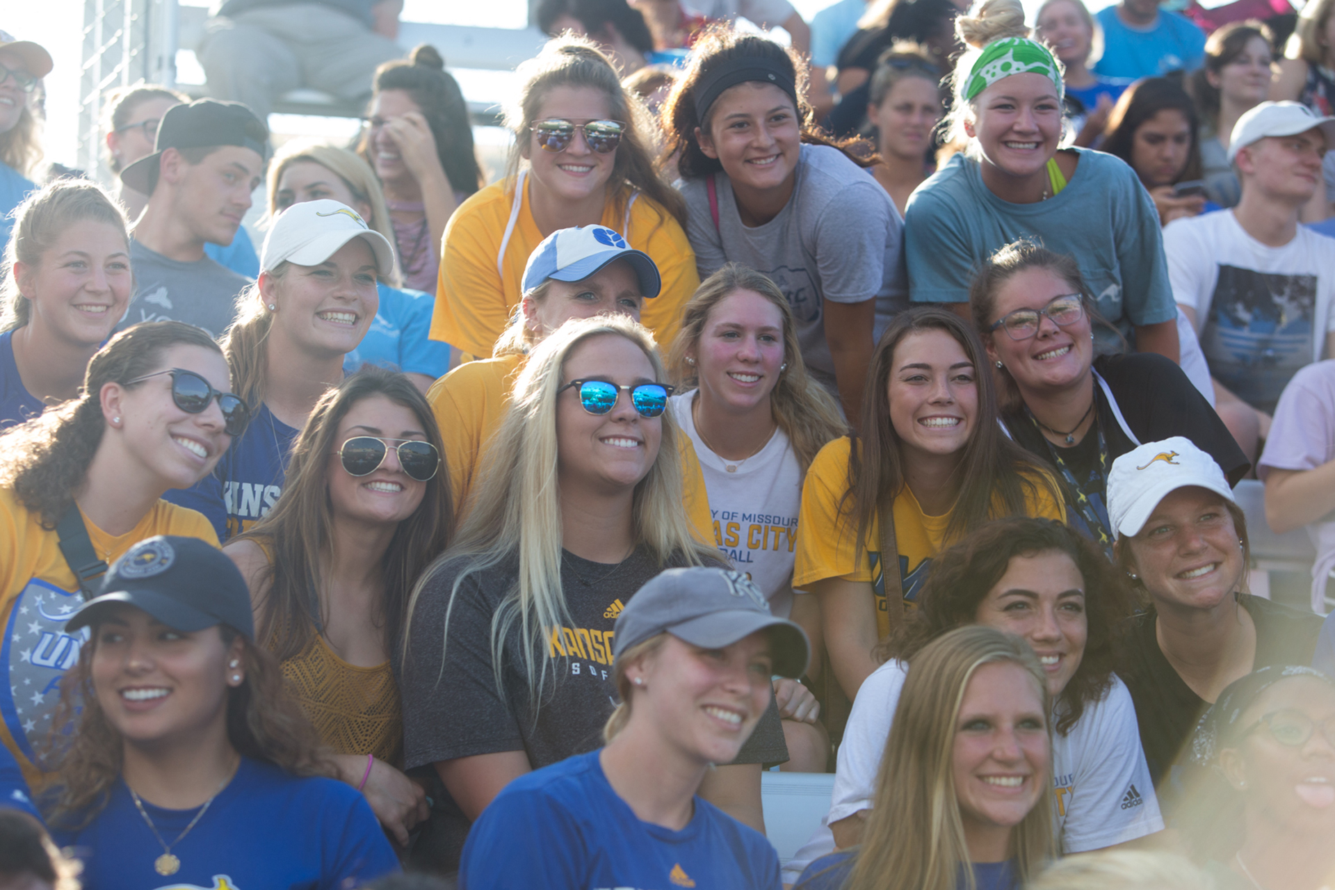 group of mostly white female students smiles for camera at a sporting event
